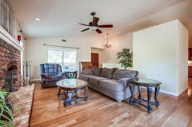 163 Wylerhorn Dr, Crestline, CA 92325 - living room with a brick fireplace, light wood-style flooring, a ceiling fan, vaulted ceiling, and a chandelier