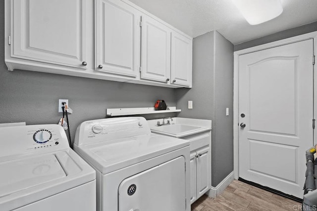 2128 Cantata # 38, Chula Vista, CA 91914 - laundry area with washer and clothes dryer, light wood-style flooring, and cabinet space