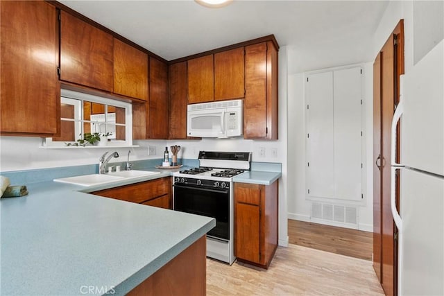 2892 Los Feliz Ct Unit 37, San Luis Obispo, CA 93401 - kitchen featuring white appliances, light wood-style floors, brown cabinetry, and light countertops