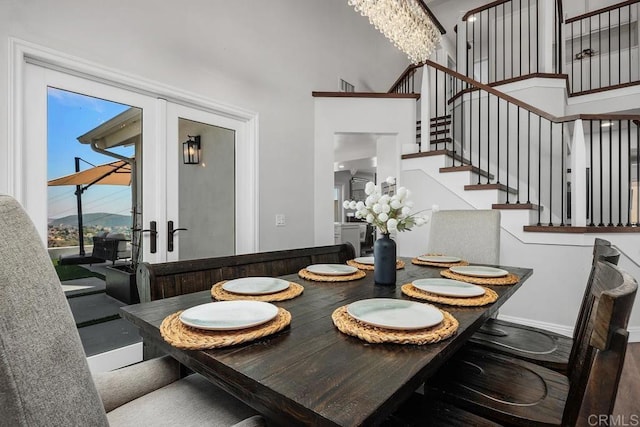 13655 Quinton Rd, San Diego, CA 92129 - dining area featuring stairs, a towering ceiling, and a chandelier