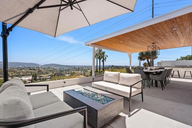 13655 Quinton Rd, San Diego, CA 92129 - view of patio featuring an outdoor living space with a fire pit, a mountain view, outdoor dining space, and an outdoor kitchen