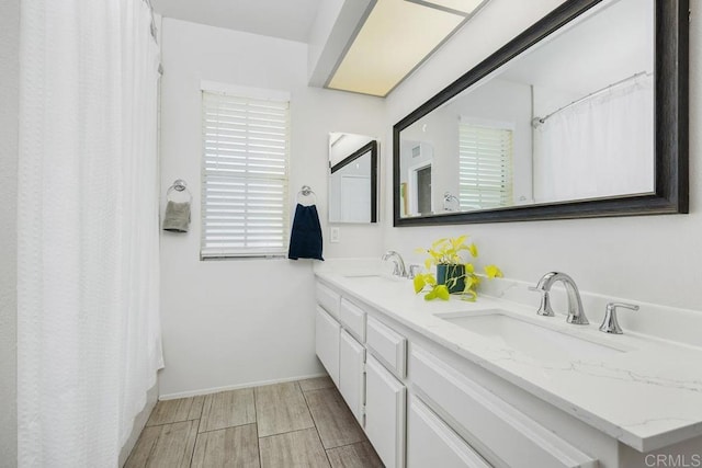13655 Quinton Rd, San Diego, CA 92129 - full bathroom featuring double vanity and wood finish floors
