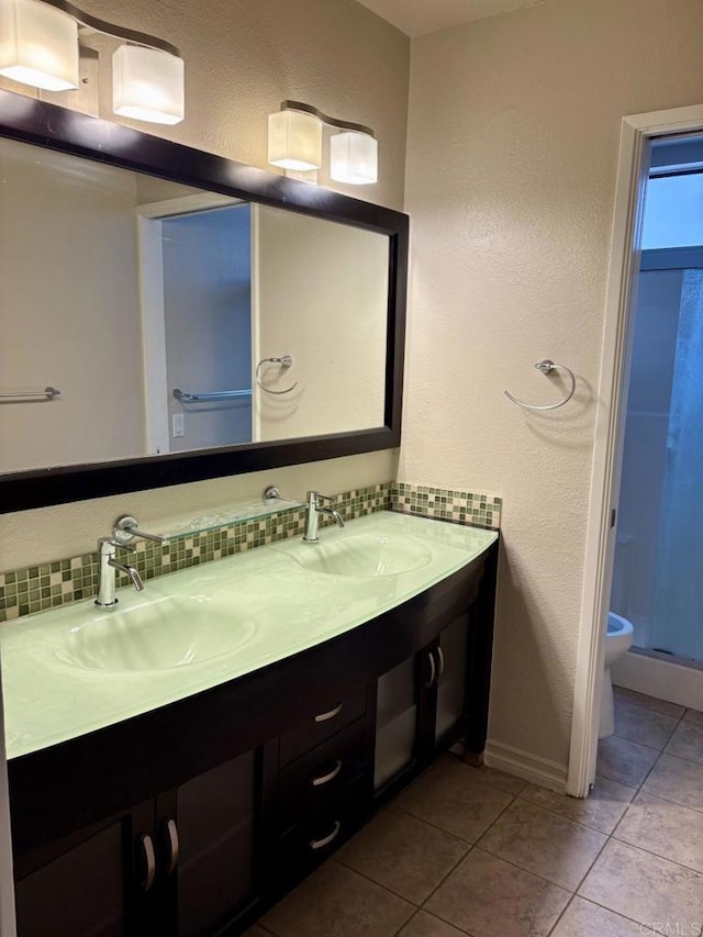 989 Ashton Ct, Vista, CA 92081 - full bath with double vanity, tile patterned floors, decorative backsplash, and a stall shower