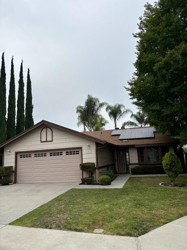 989 Ashton Ct, Vista, CA 92081 - ranch-style house featuring driveway, a front lawn, roof mounted solar panels, and a garage