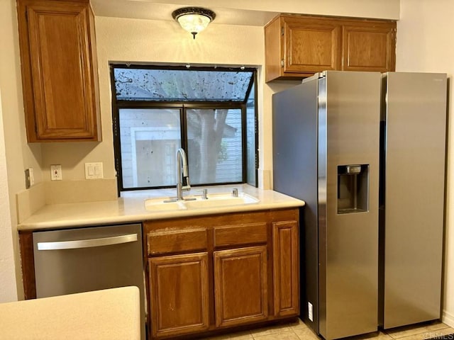 989 Ashton Ct, Vista, CA 92081 - kitchen with stainless steel appliances, brown cabinets, and light countertops