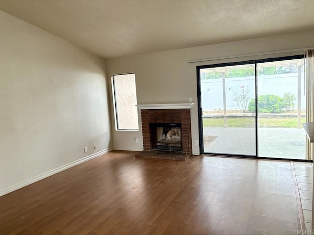 989 Ashton Ct, Vista, CA 92081 - unfurnished living room with wood finished floors and a brick fireplace