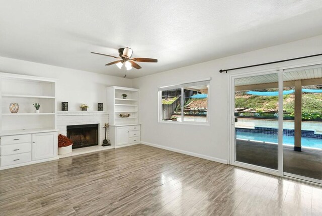 2760 Fieldbrook Way, Escondido, CA 92027 - unfurnished living room with a ceiling fan, a brick fireplace, and wood finished floors