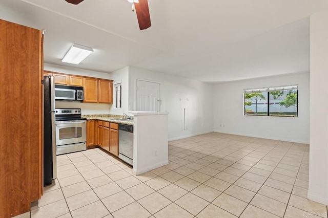 12191 Cuyamaca College Dr E Unit 213, El Cajon, CA 92019 - kitchen featuring appliances with stainless steel finishes, a peninsula, light tile patterned flooring, and open floor plan