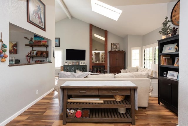 11705 Via Medanos, San Diego, CA 92128 - living area featuring beamed ceiling, wood finished floors, high vaulted ceiling, and a skylight