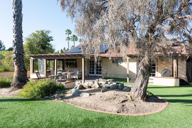 11705 Via Medanos, San Diego, CA 92128 - back of property with roof mounted solar panels, a lawn, stucco siding, french doors, and a patio