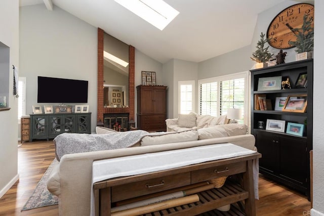 11705 Via Medanos, San Diego, CA 92128 - living room with wood finished floors, beam ceiling, a skylight, and high vaulted ceiling