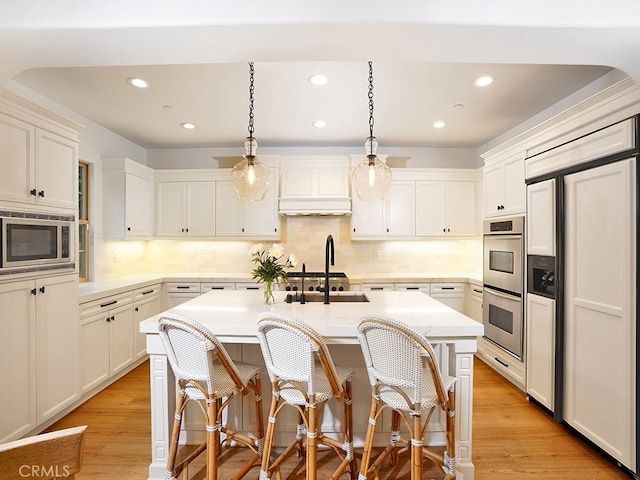 29 Via Timon, San Clemente, CA 92673 - kitchen with built in appliances, premium range hood, light countertops, recessed lighting, and light wood finished floors
