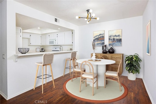 25644 Mont Pointe Unit 1A, Lake Forest, CA 92630 - dining area with dark wood-style floors and a chandelier