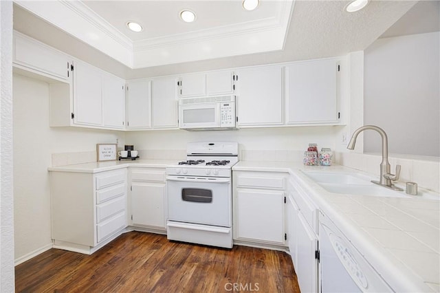 25644 Mont Pointe Unit 1A, Lake Forest, CA 92630 - kitchen featuring white appliances, dark wood-style flooring, a raised ceiling, white cabinets, and recessed lighting