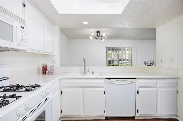 25644 Mont Pointe Unit 1A, Lake Forest, CA 92630 - kitchen featuring white appliances, white cabinetry, a chandelier, light countertops, and a textured ceiling