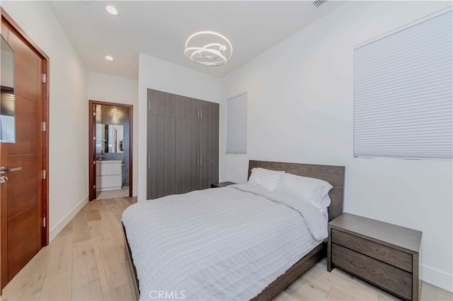 615 El Redondo Ave, Redondo Beach, CA 90277 - bedroom with light wood-type flooring, recessed lighting, a chandelier, a closet, and ensuite bath