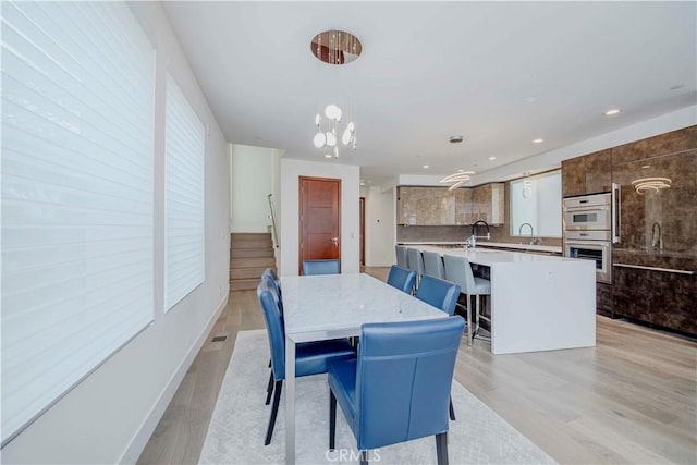 615 El Redondo Ave, Redondo Beach, CA 90277 - dining space with light wood-style floors, healthy amount of natural light, a chandelier, and recessed lighting