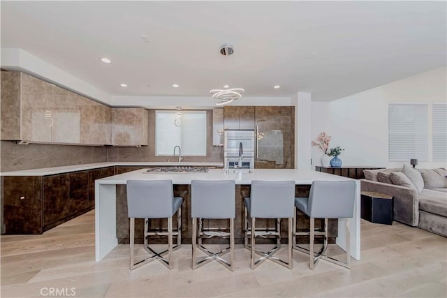 615 El Redondo Ave, Redondo Beach, CA 90277 - kitchen with a kitchen breakfast bar, stainless steel double oven, pendant lighting, a large island, and recessed lighting