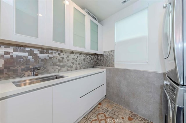 615 El Redondo Ave, Redondo Beach, CA 90277 - kitchen with stacked washing machine and dryer, freestanding refrigerator, white cabinets, and light countertops