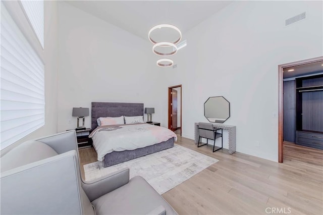 615 El Redondo Ave, Redondo Beach, CA 90277 - bedroom featuring a high ceiling, wood finished floors, and a walk in closet