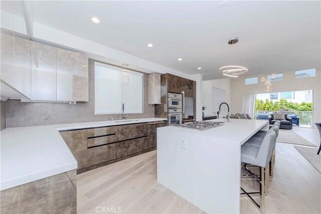615 El Redondo Ave, Redondo Beach, CA 90277 - kitchen featuring modern cabinets, light wood finished floors, light countertops, open floor plan, and recessed lighting
