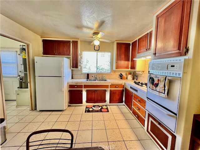 8675 Colorado Ave, Riverside, CA 92504 - kitchen with white appliances, a warming drawer, a ceiling fan, tile countertops, and light tile patterned floors