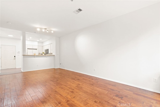 6400 Crescent E Unit 121, Playa Vista, CA 90094 - unfurnished living room with light wood finished floors and track lighting