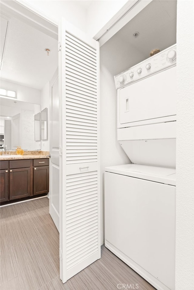 6400 Crescent E Unit 121, Playa Vista, CA 90094 - laundry area with stacked washer / dryer and light wood-type flooring