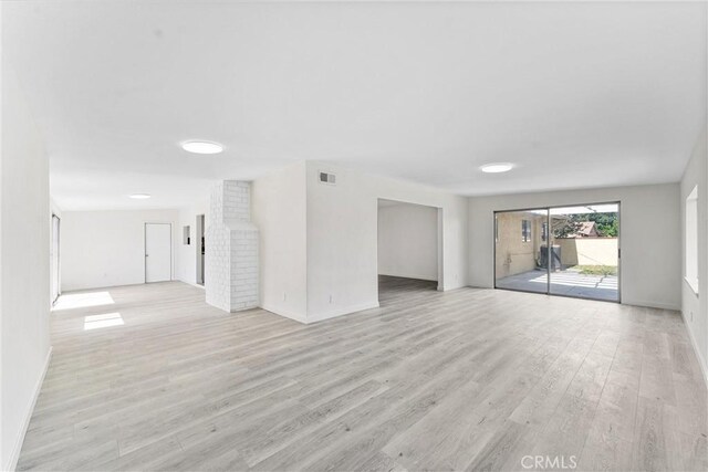 558 W Philadelphia St, Ontario, CA 91762 - unfurnished living room featuring baseboards and light wood-type flooring