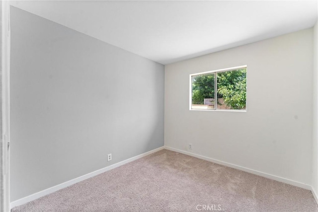 558 W Philadelphia St, Ontario, CA 91762 - carpeted empty room featuring baseboards