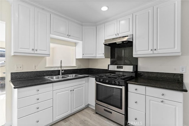 558 W Philadelphia St, Ontario, CA 91762 - kitchen with stainless steel range with gas cooktop, under cabinet range hood, dark countertops, white cabinetry, and recessed lighting