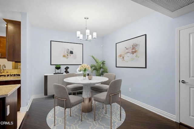 4424 Whitsett Ave Unit 102, Studio City, CA 91604 - dining space featuring a chandelier and dark wood-style floors
