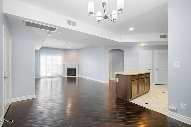 4424 Whitsett Ave Unit 102, Studio City, CA 91604 - unfurnished living room with light wood-style floors, arched walkways, recessed lighting, a chandelier, and a fireplace with raised hearth
