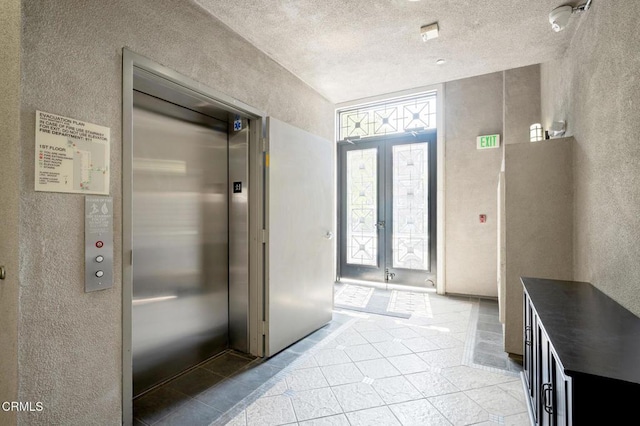 4424 Whitsett Ave Unit 102, Studio City, CA 91604 - bathroom featuring a textured wall, french doors, elevator, tile patterned floors, and a textured ceiling