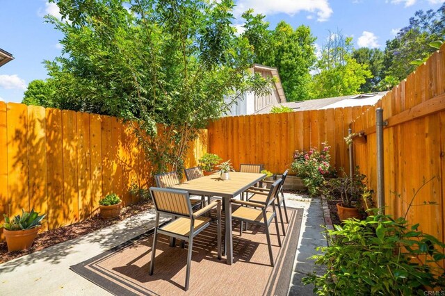 6660 Bell Bluff Ave Unit A, San Diego, CA 92119 - fenced backyard with a patio and outdoor dining area