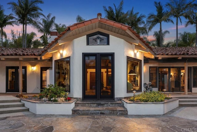 9 Rolling View Ln, Fallbrook, CA 92028 - exterior entry at dusk featuring a tiled roof and stucco siding