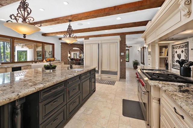9 Rolling View Ln, Fallbrook, CA 92028 - kitchen featuring stainless steel range, cream cabinetry, beamed ceiling, recessed lighting, and dark cabinetry