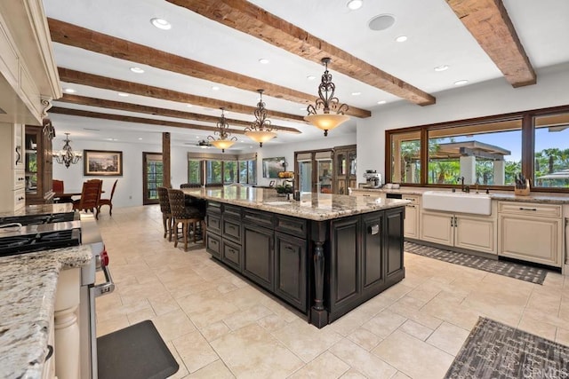 9 Rolling View Ln, Fallbrook, CA 92028 - kitchen with cream cabinetry, beamed ceiling, dark cabinets, recessed lighting, and pendant lighting