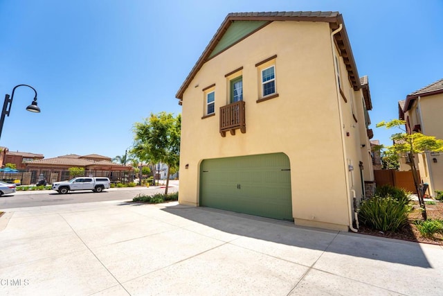 1655 Range Rd, Oxnard, CA 93036 - view of side of home featuring a garage and stucco siding