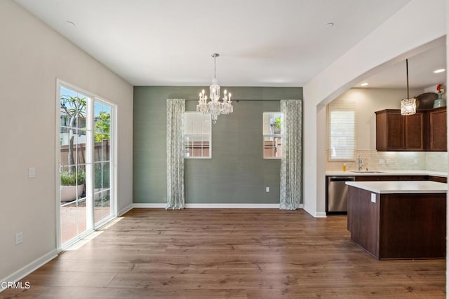 1655 Range Rd, Oxnard, CA 93036 - unfurnished dining area featuring a chandelier, dark wood-type flooring, and arched walkways