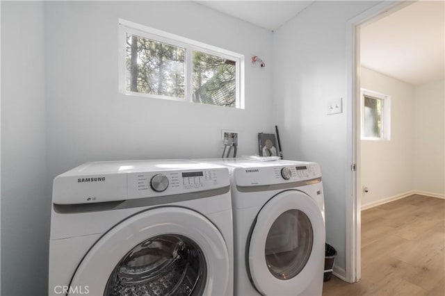 1044 E Country Club Blvd, Big Bear City, CA 92314 - washroom with washing machine and clothes dryer, healthy amount of natural light, and light wood-style floors