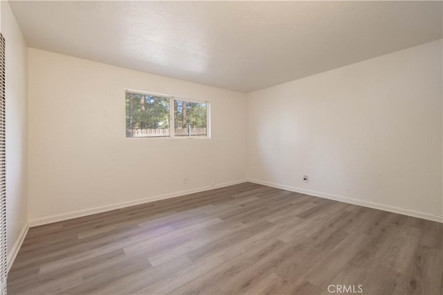 1044 E Country Club Blvd, Big Bear City, CA 92314 - empty room featuring wood finished floors and a heating unit