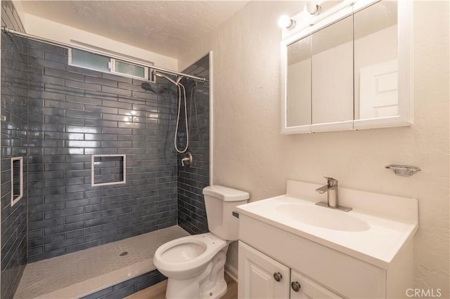 1044 E Country Club Blvd, Big Bear City, CA 92314 - bathroom with vanity, a tile shower, a textured wall, and a textured ceiling
