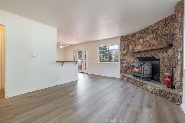 1044 E Country Club Blvd, Big Bear City, CA 92314 - unfurnished living room with french doors, wood finished floors, and a wood stove