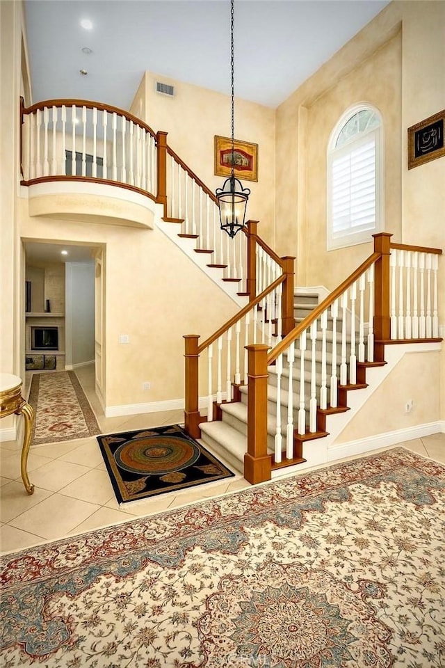 162 Dusty Rose Ct, Simi Valley, CA 93065 - staircase featuring tile patterned floors and a towering ceiling