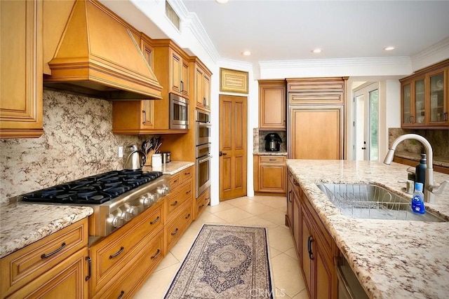 162 Dusty Rose Ct, Simi Valley, CA 93065 - kitchen featuring custom exhaust hood, stainless steel appliances, light stone counters, tasteful backsplash, and brown cabinets