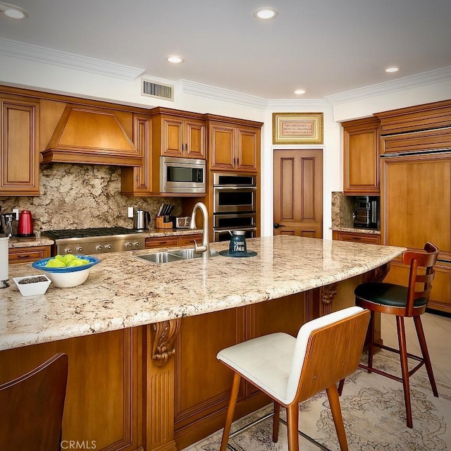 162 Dusty Rose Ct, Simi Valley, CA 93065 - kitchen with built in appliances, custom range hood, decorative backsplash, light stone countertops, and brown cabinets