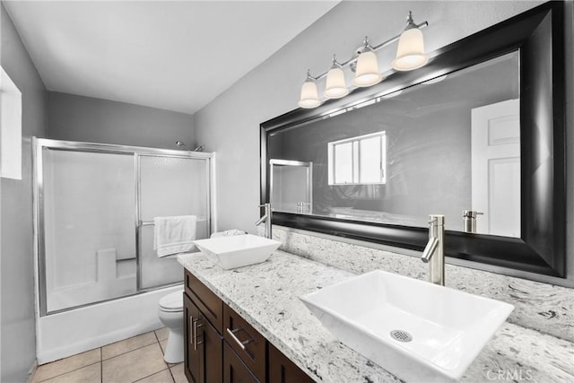 1571 S Reservoir St Unit C, Pomona, CA 91766 - bathroom with double vanity, bath / shower combo with glass door, and tile patterned flooring