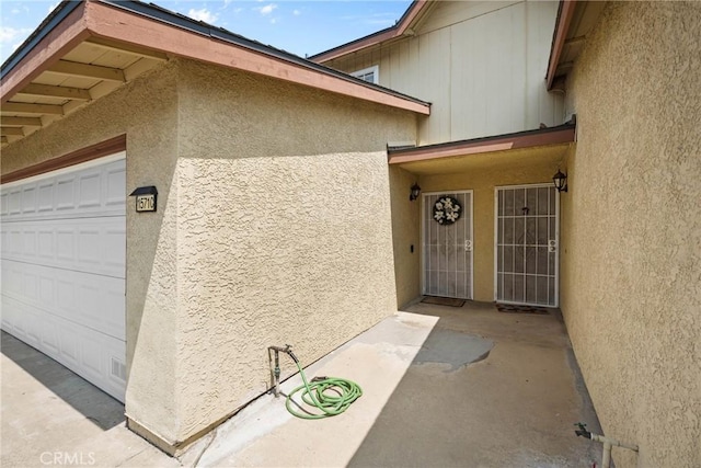 1571 S Reservoir St Unit C, Pomona, CA 91766 - doorway to property featuring stucco siding and an attached garage