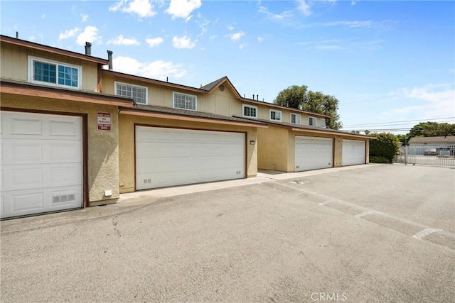 1571 S Reservoir St Unit C, Pomona, CA 91766 - townhome / multi-family property featuring community garages and stucco siding